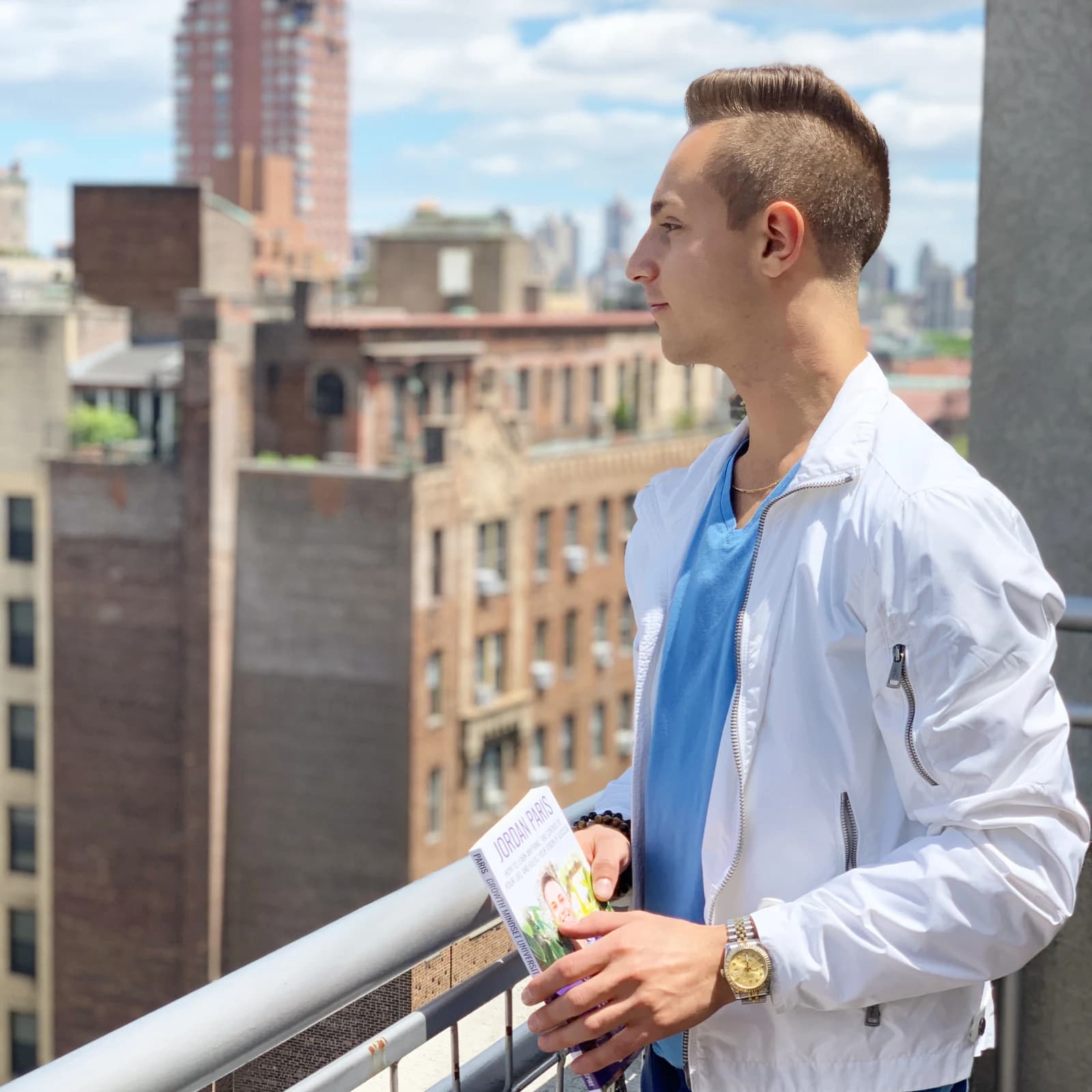 Jordan holding Growth Mindset University above the New York rooftops.