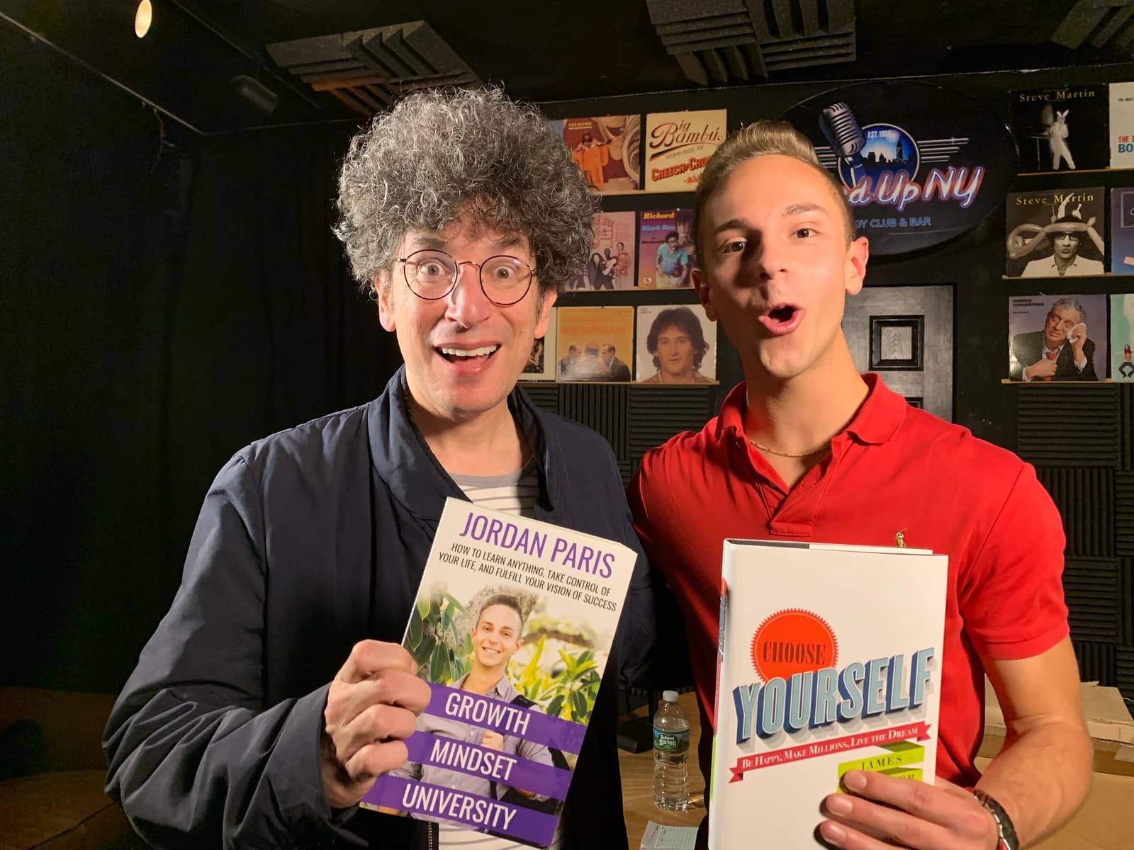 Jordan and James Altucher holding each other's books.